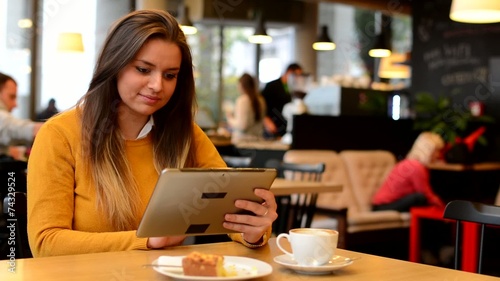 woman works on tablet in cafe - coffee and cake