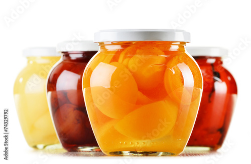 Jars with fruity compotes isolated on white. Preserved fruits
