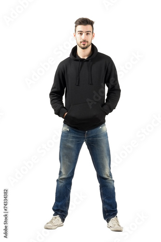 Confident man in hood with hands in pockets