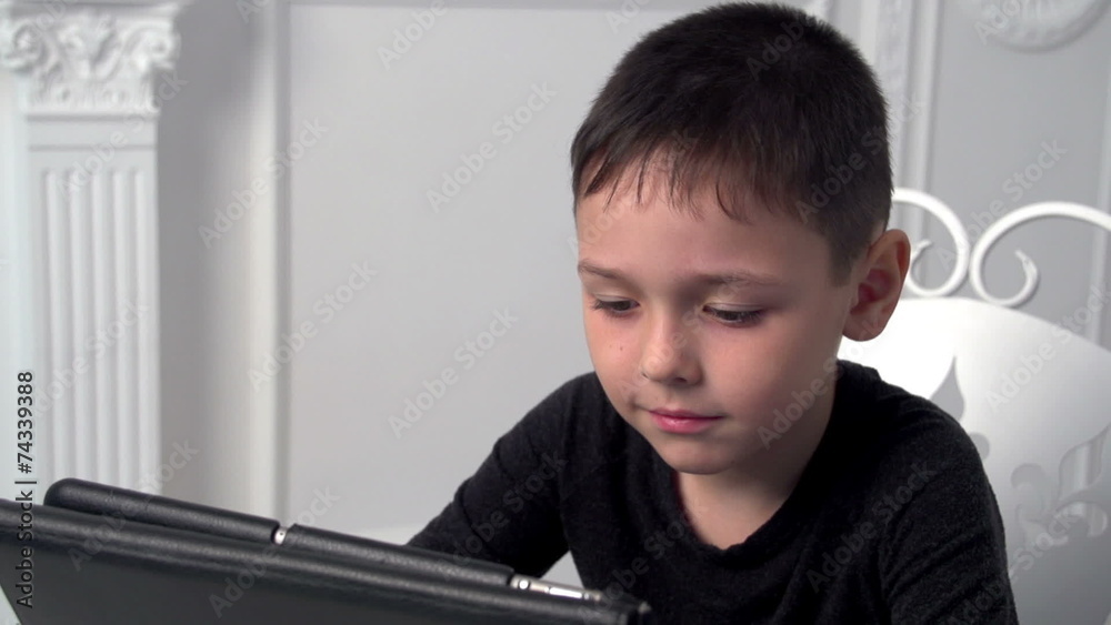 boy playing in the tablet, slow motion, dolly 1 boy playing in the tablet, slow motion, dolly 1
