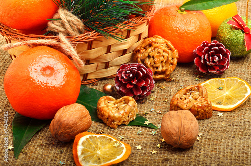 Christmas tangerines with dried lemon, walnuts, pinecone and bri