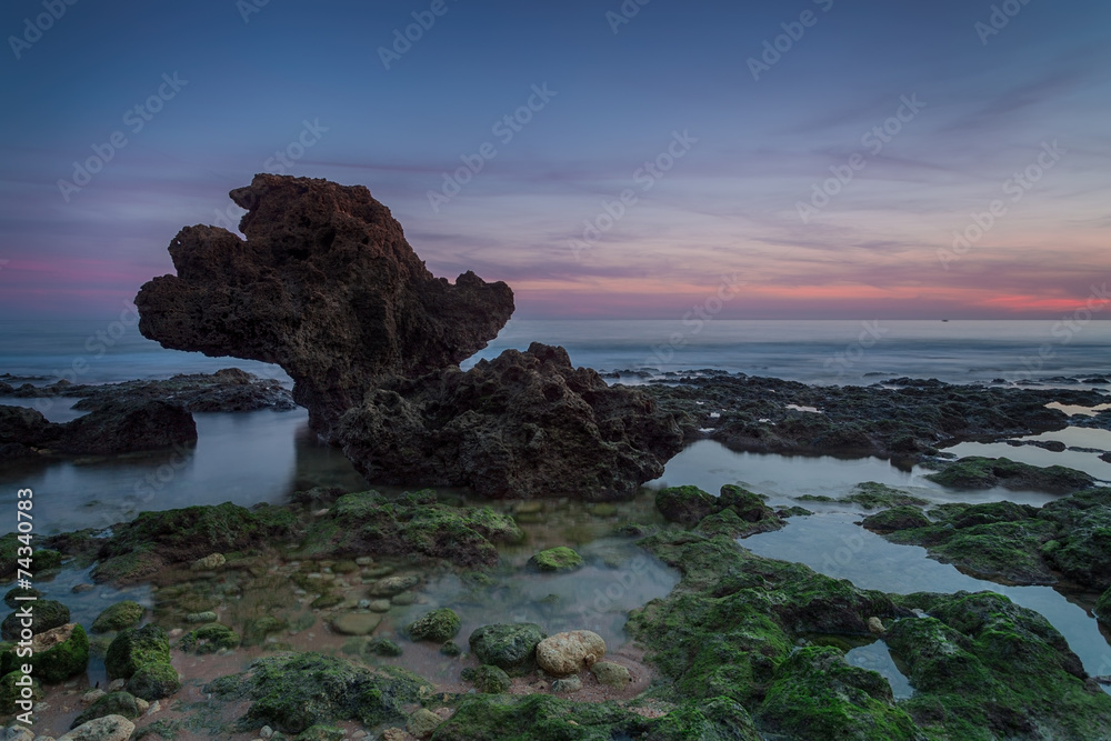 Beautiful sea sunset on a background elegant stone.