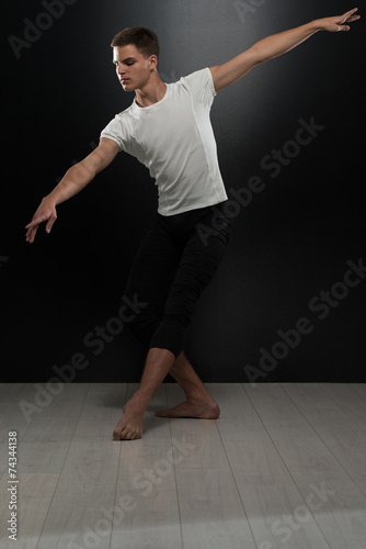 Portrait Of Young Ballet Dancer On Black Background