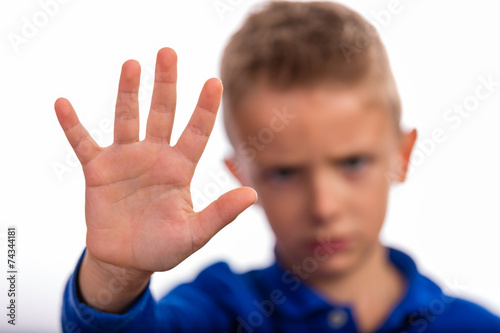 Boy making a stop gesture with his hand