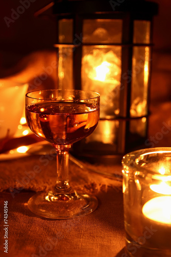 Glass of calvados on the background of a burning torch.