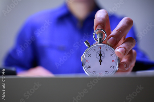 Workshop director holding a stopwatch