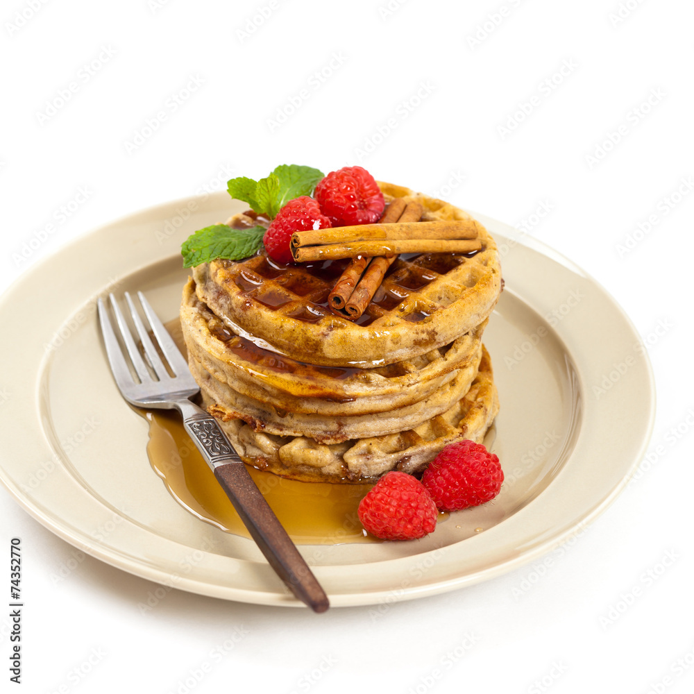 Waffles with raspberries and cinnamon. Selective focus. Waffles with raspberries and cinnamon. Selective focus.
