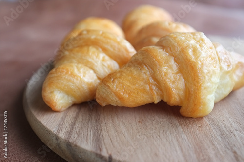 Croissants on wood and  leather background © sunstep
