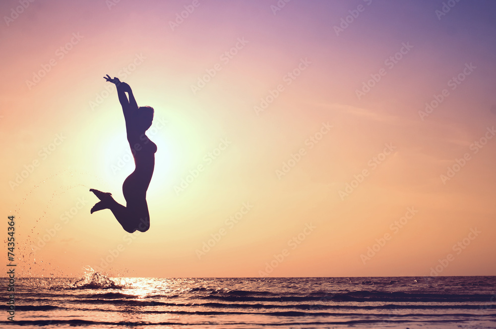 Happy Woman Jumping on the beach