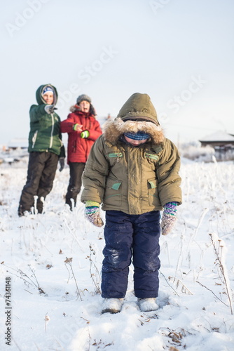 children mock child outdoors in winter on the street
