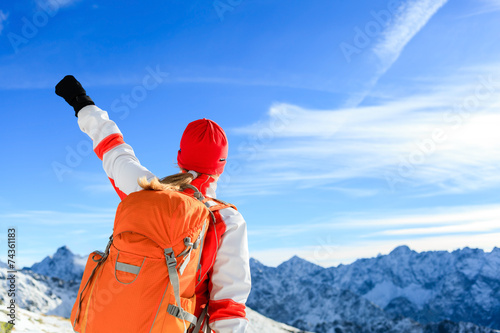 Hiking success, happy woman in winter mountains