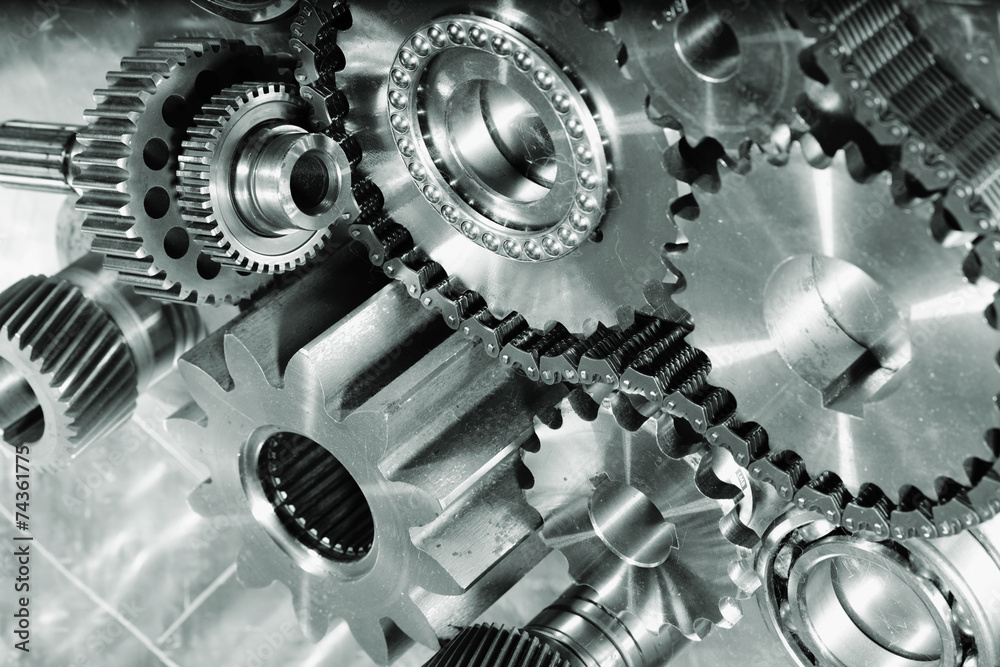 engineering parts and cogs against titanium backdrop engineering parts and cogs against titanium backdrop