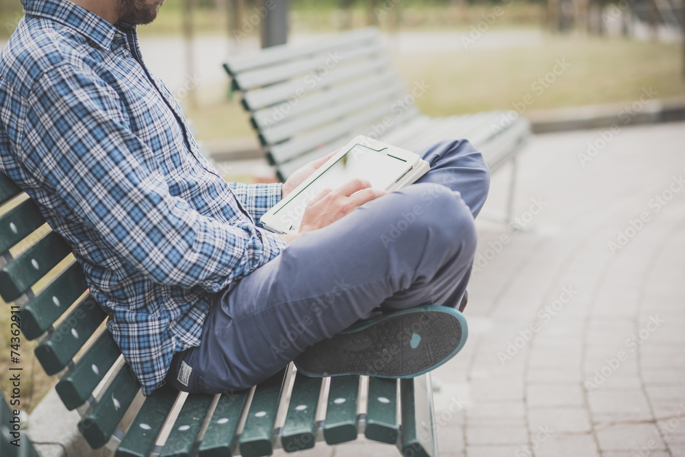 handsome hipster casual multitasking modern man using tablet