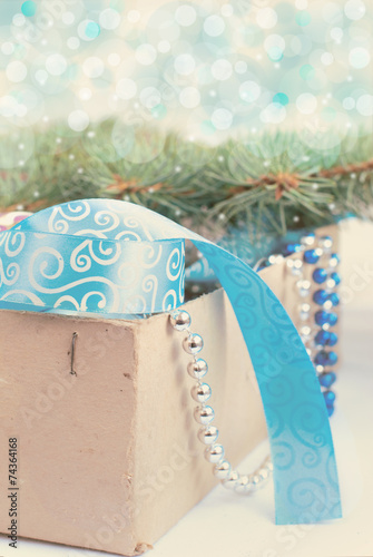 box with Christmas toys, blue and silver beads, blue ribbon and photo