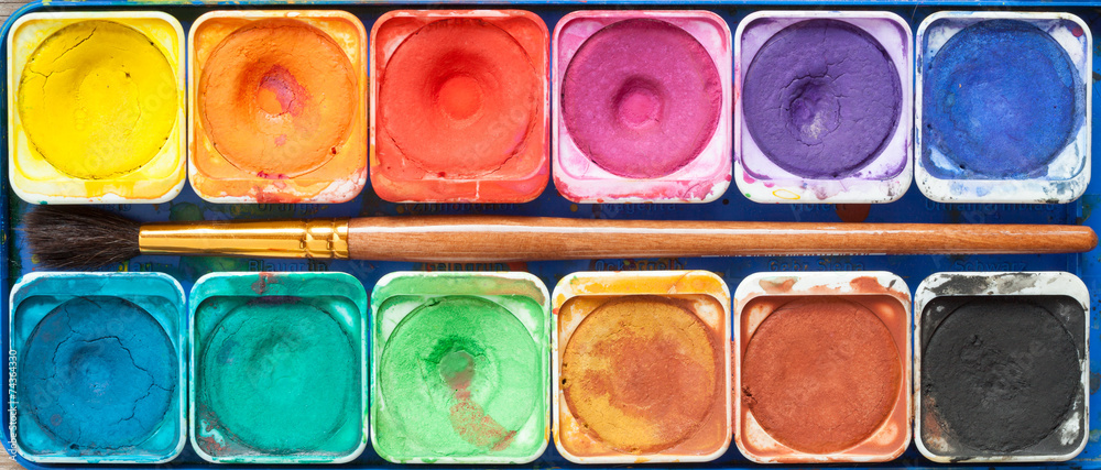 Fototapeta premium Set of watercolor paints and paintbrush.