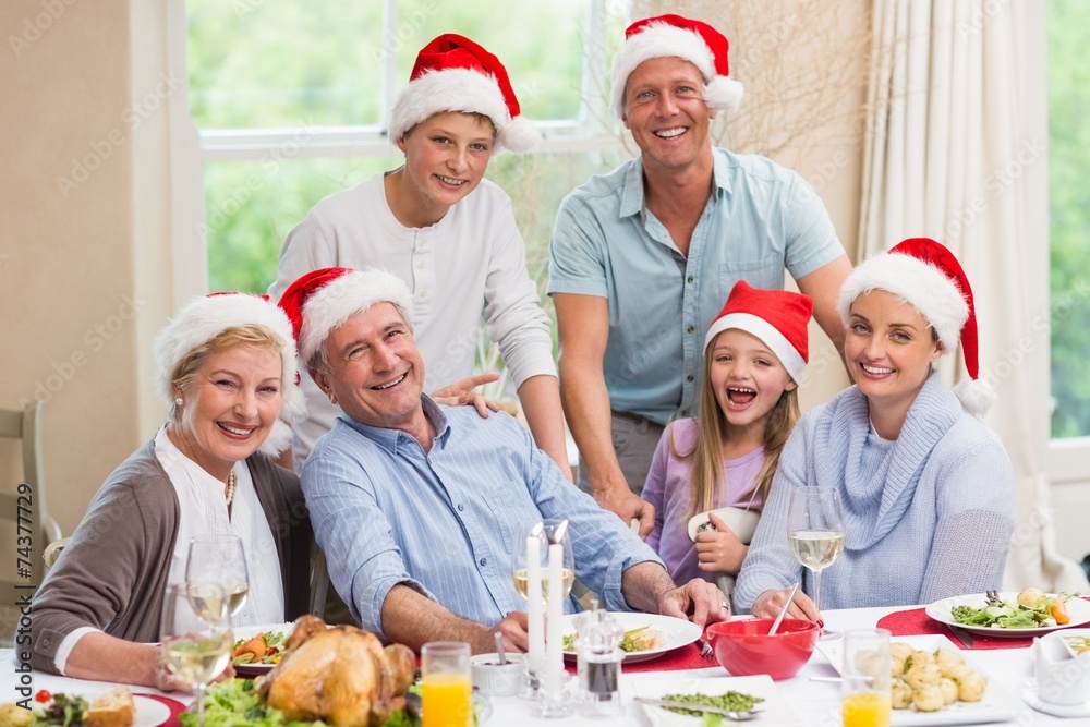 Happy family in santa hat looking at camera Happy family in santa hat looking at camera