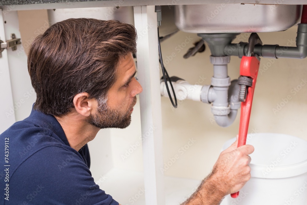 Plumber fixing under the sink Plumber fixing under the sink