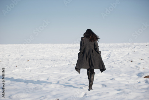 beautiful girl alone in winter field