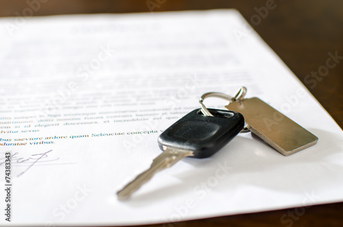 Car key on a signed sales contract