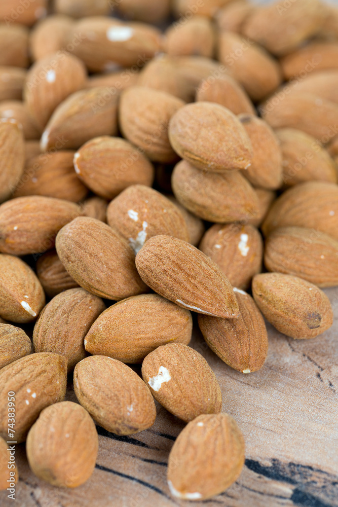 almond nuts on wooden surface almond nuts on wooden surface