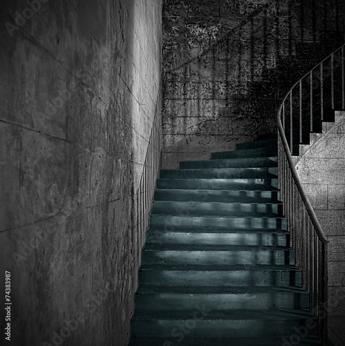 Spooky old stone interior staircase with rusty handrail
