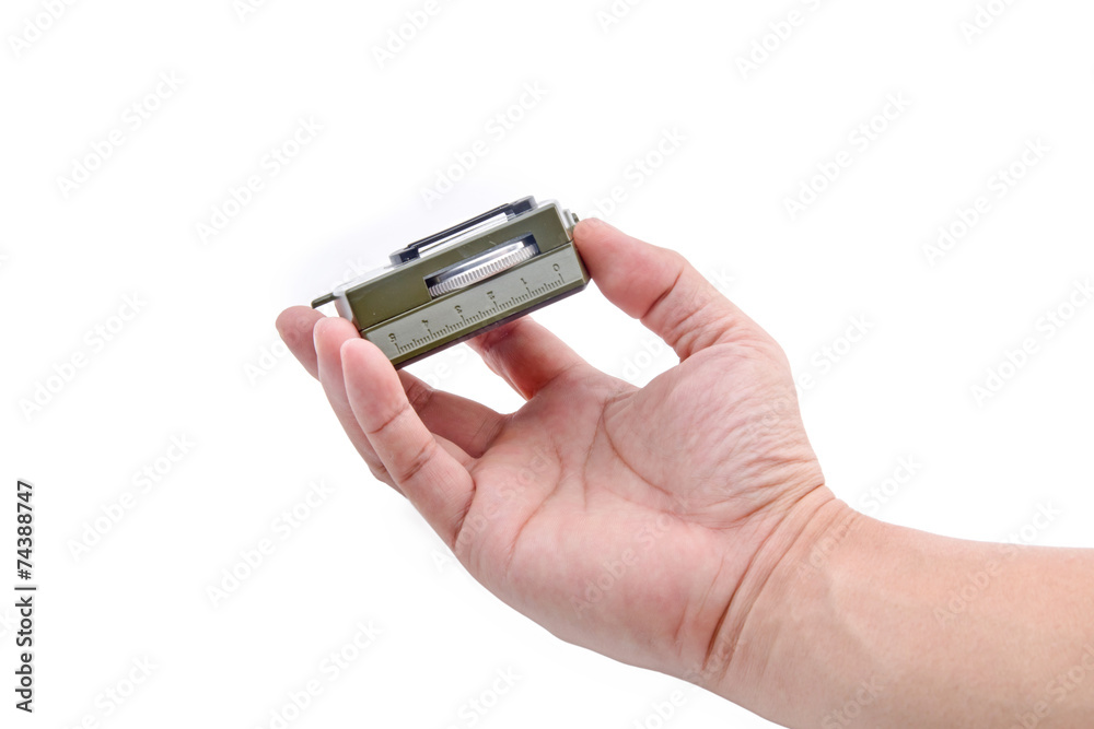 The hand holding the Army green Compass isolation on white. The hand holding the Army green Compass isolation on white.