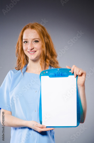 Young woman doctor with book