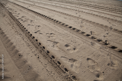 Human and tire traces in the sand