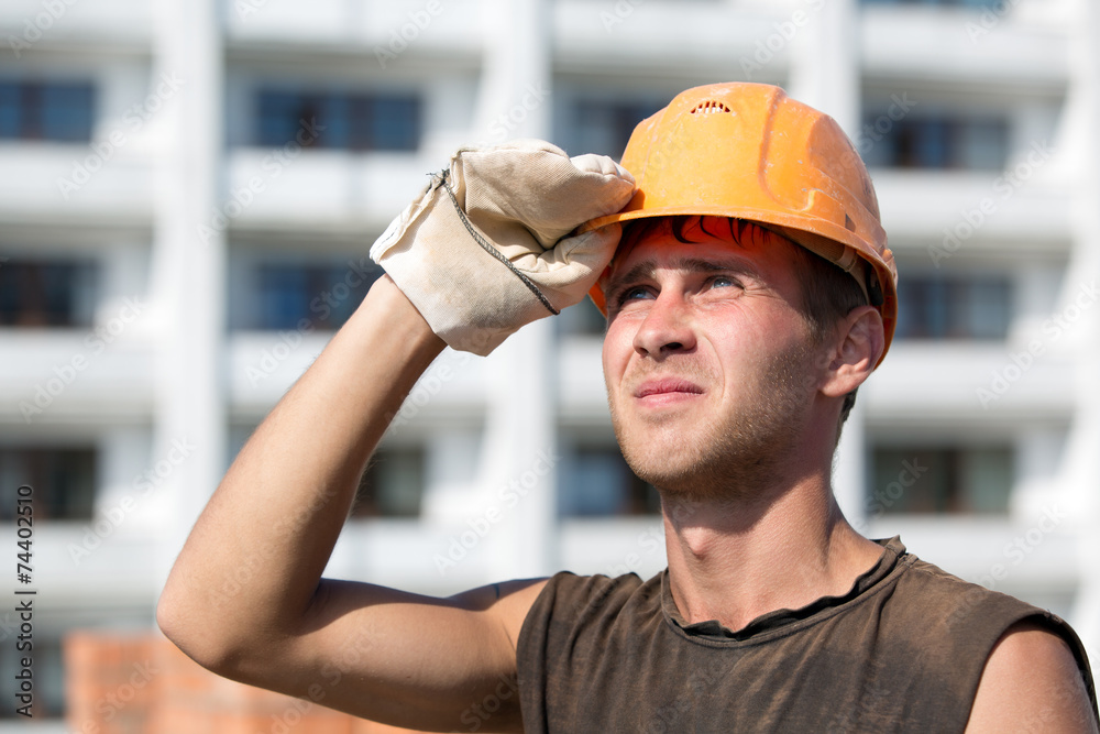 Builder man worker with hard hat looking into distance Builder man worker with hard hat looking into distance
