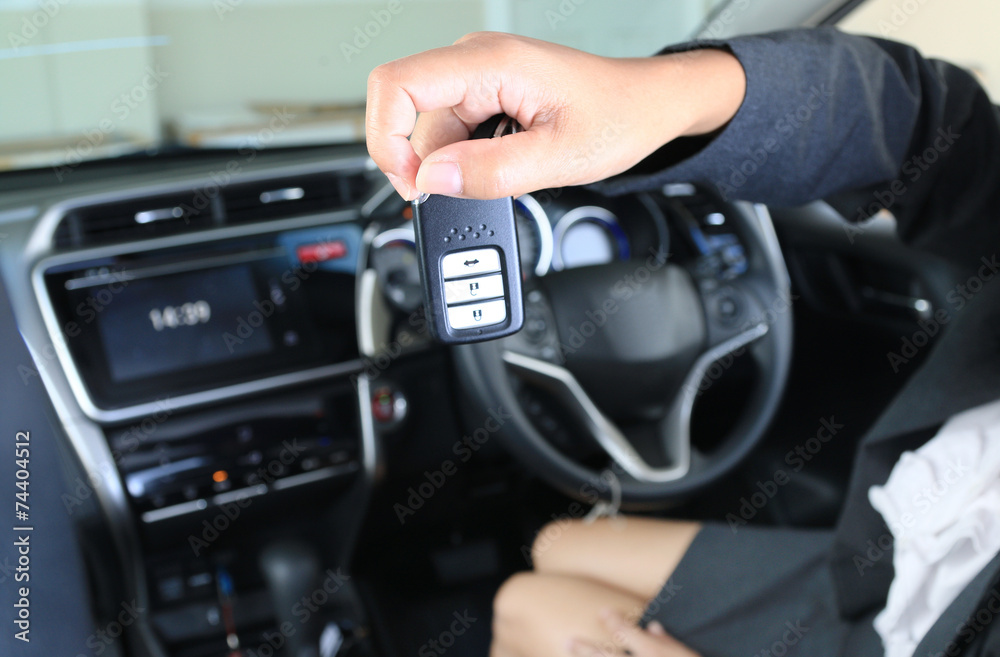 Business woman show remote key in mordern vehicle car. Business woman show remote key in mordern vehicle car.