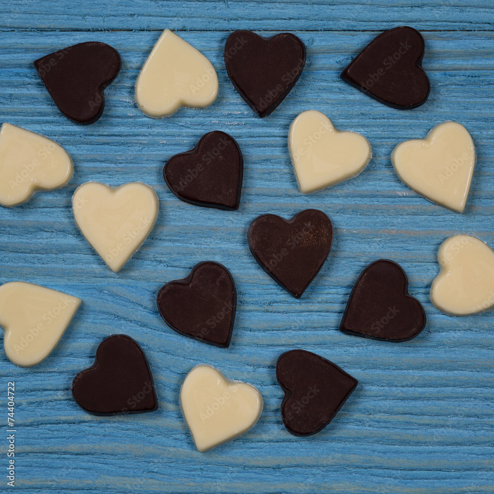 Obraz premium Chocolate hearts on a wooden background