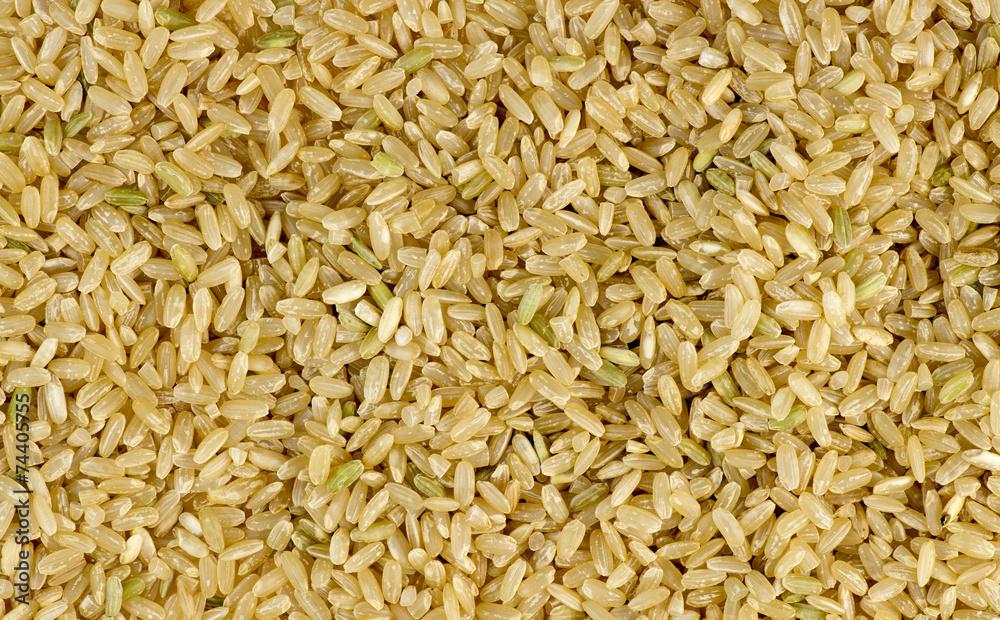 Overhead macro shot of uncooked raw brown rice background textur Overhead macro shot of uncooked raw brown rice background textur