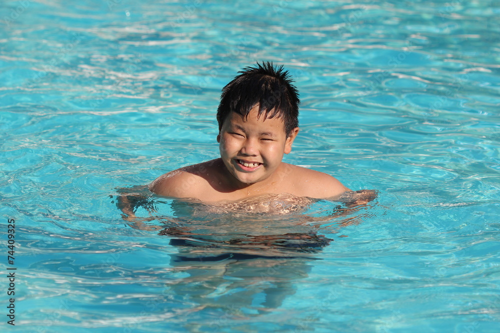 Asian boy in the swimming pool..