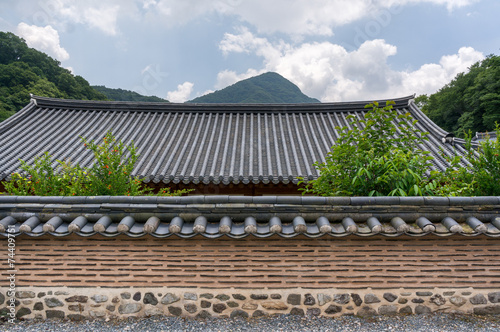 Traditional Buddhist temple wall and rooftop.