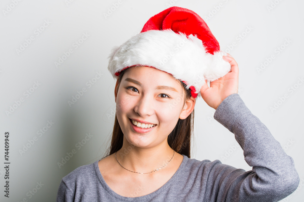 Young asian woman with Christmas hat isolated on white. Young asian woman with Christmas hat isolated on white.