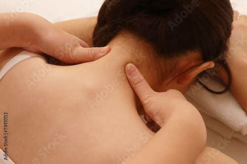 Deep massage on a woman's neck