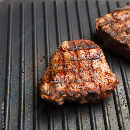 fresh fried steak on a grill pan