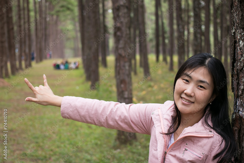 Girl with a smail in pine plantation Girl with a smail in pine plantation