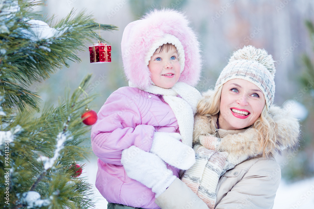 Happy mother and child with decorated christmas tree outdoor Happy mother and child with decorated christmas tree outdoor