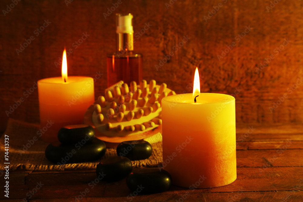 Spa stones, oil and candles on wooden background Spa stones, oil and candles on wooden background