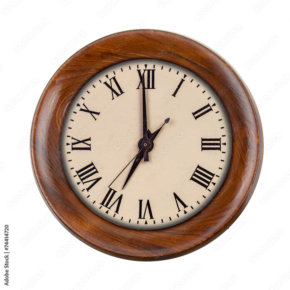 Vintage clockface showing seven o'clock in wooden frame