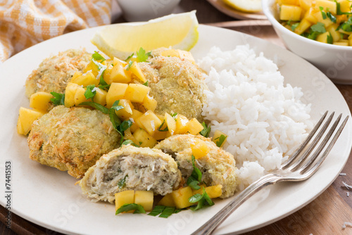 fish cakes with mango salsa and rice, close-up