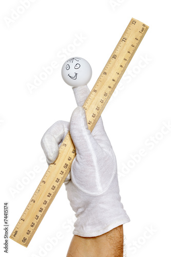 Finger puppet holding wooden rule