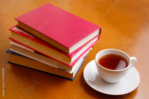 Cup of tea and stack of books