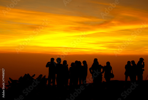 group of people on top of a mountain waiting for take photo with