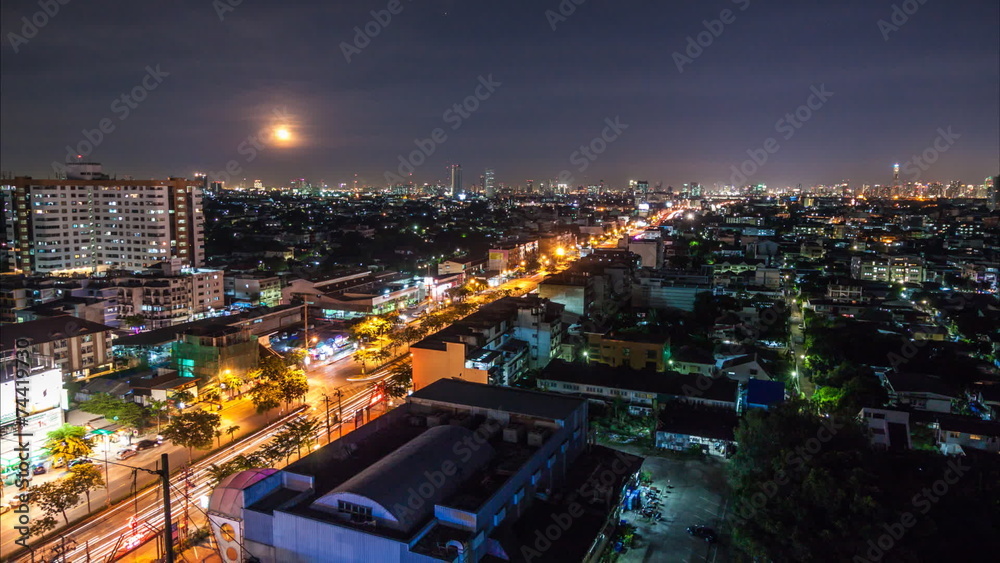 Timelapse of traffic and rising moon over Bangkok building and sky Timelapse of traffic and rising moon over Bangkok building and sky