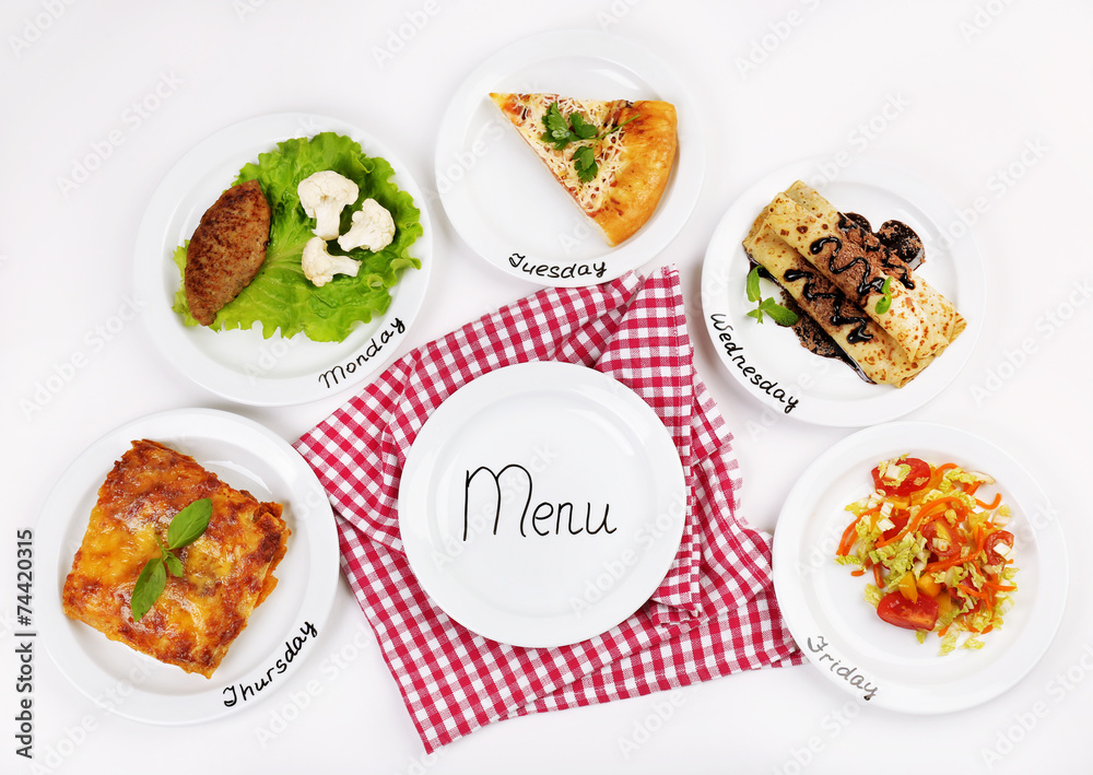 Daily menu. Plates with food on table Daily menu. Plates with food on table