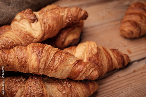Some croissants on a wooden surface