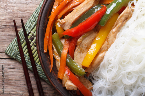 Asian food chicken with rice noodles macro horizontal top view