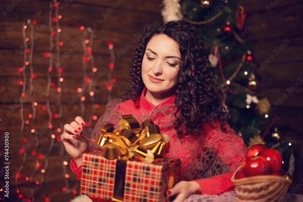 Cute woman with candle next to christmas tree Cute woman with candle next to christmas tree